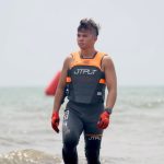 Makayo Waverunner rider walking through the waves during international jetski racing event