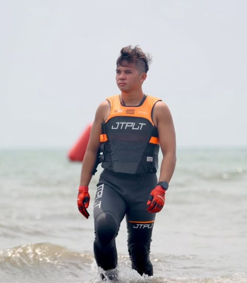 Makayo Waverunner rider walking through the waves during international jetski racing event